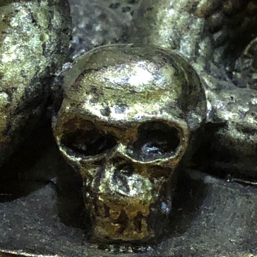 Decorative figurine with snakes and skulls