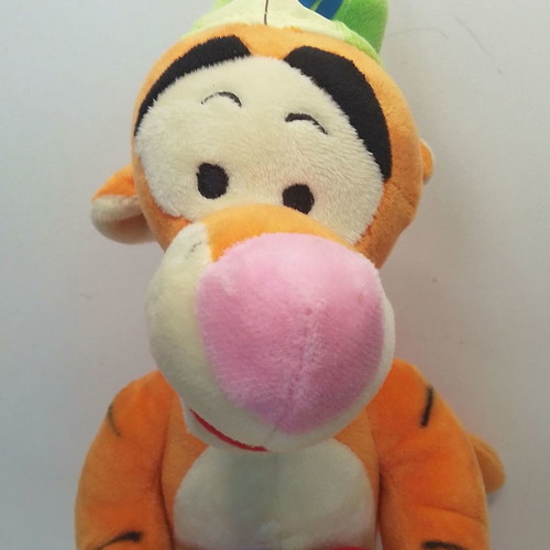 Disney Winnie Tigger plush used with birthday party hat