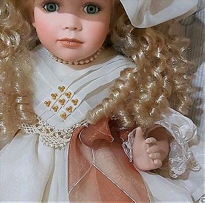 Κούκλα από πορσελάνη       80s ύψους 55cm. Φόρεμα από οργαντζα με δαντέλα, κοσμήματα πέρλες