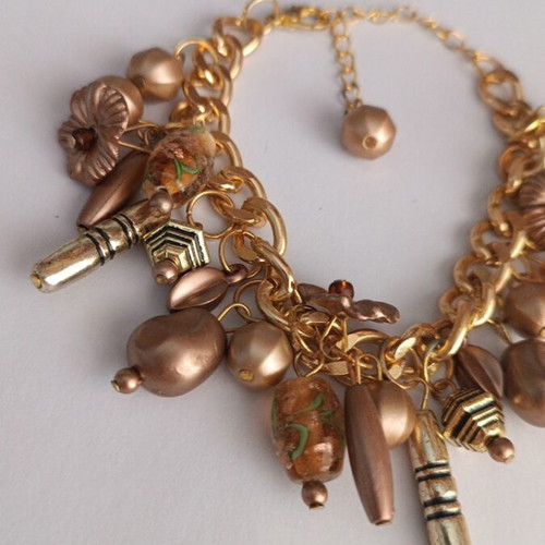 Gold bracelet with various charms handmade from scratch