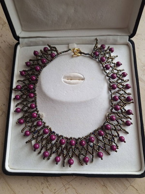 Handmade necklace with weaving and purple beads