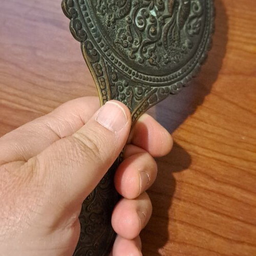Brass hand mirror used with embossed peacock decoration