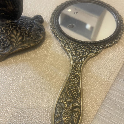 Set of two brass mirrors, table and hand used