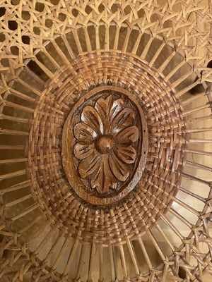 Oval living room coffee table with rattan and carved medallion