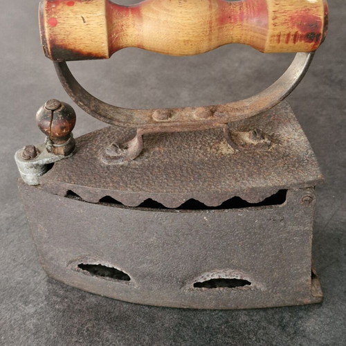 Vintage coal iron used with wooden handle and patina