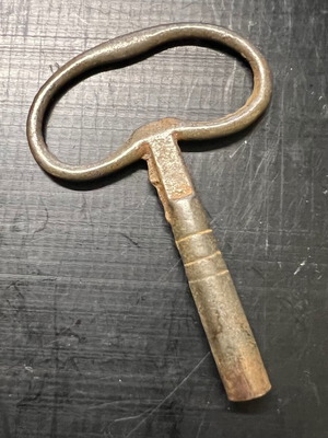 Large winding key used, early 1900s vintage