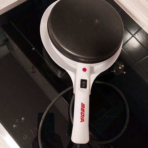 Electric handheld crepe maker like new with non-stick surface