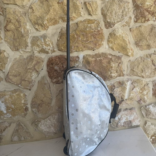 Smiley metallic travel bag used with embossed smiley and star designs