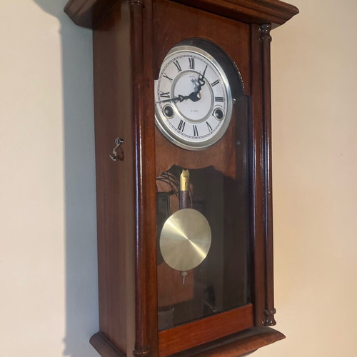 Wooden wall clock like new with pendulum and Roman numerals