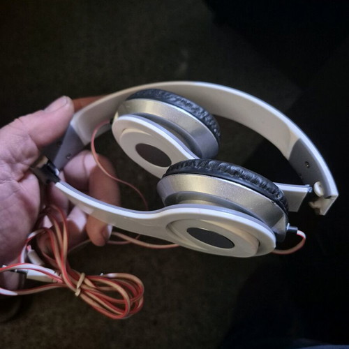 Foldable on-ear headphones used, white with silver details