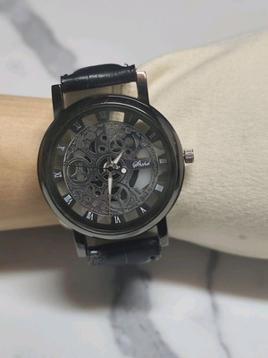 Skeleton watch like new with Roman numerals, black dial and strap