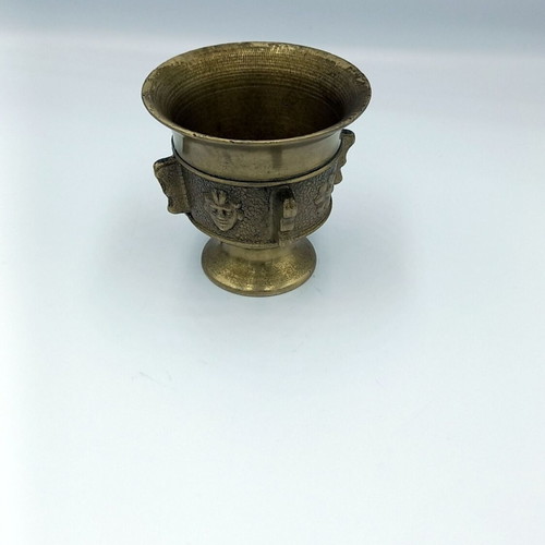 Metal mortar used with face and plant decoration