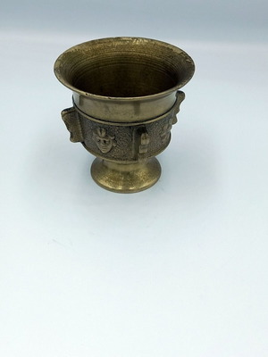 Metal mortar used with face and plant decoration