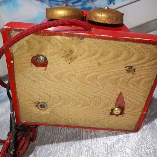 Vintage metal rotary phone, red with gold details