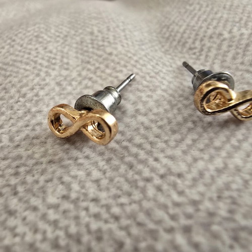 Infinity stud earrings in gold tone