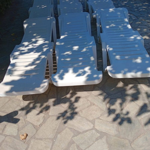 Plastic sun loungers with two wheels