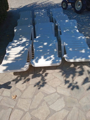 Plastic sun loungers with two wheels