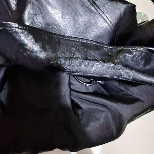 Only black biker jacket made of faux leather with silver details used