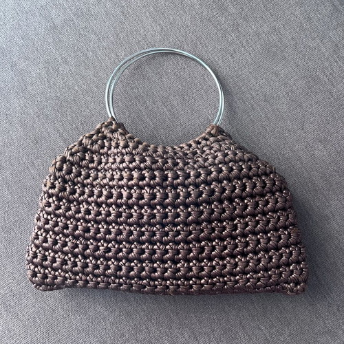 Brown metallic knitted handbag with silver ring handles