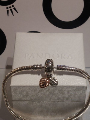 Pandora bracelet size 18 with round clasp and two leaf charms
