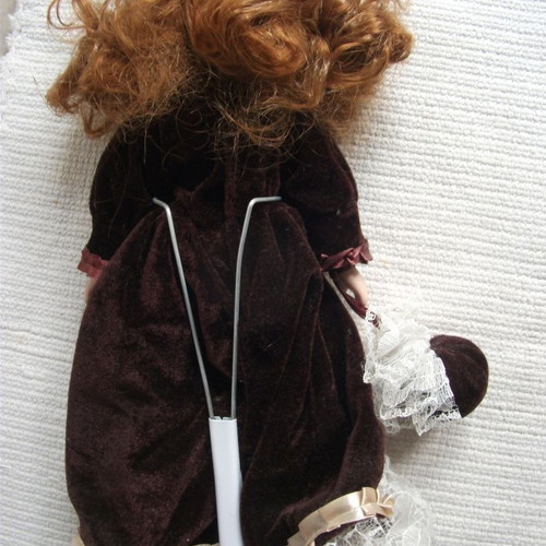 Porcelain doll used with base, box and accessories