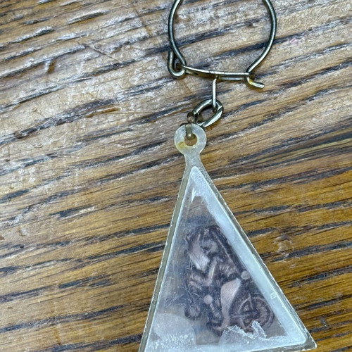 Triangle-shaped keychain used, transparent plastic with metal decoration