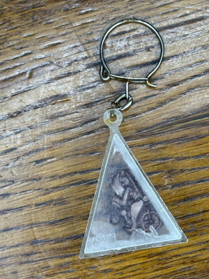 Triangle-shaped keychain used, transparent plastic with metal decoration