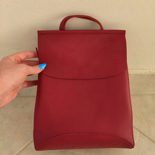 Red backpack used with broken zipper and mark