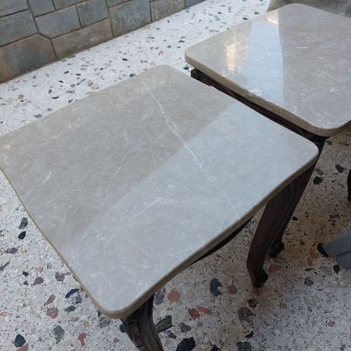 Vintage side tables pair with natural marble used