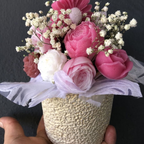 Flower arrangement with scented candles in plaster vase