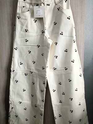 Arpyes jeans new with cherry design, size large, white and brown