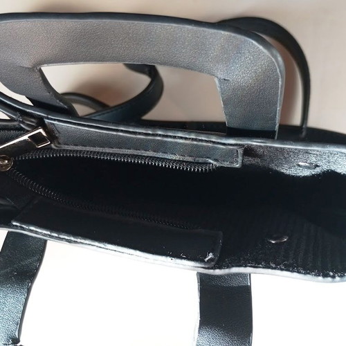 Black Women's Shoulder Bag like new with laser-cut patterns and tassels