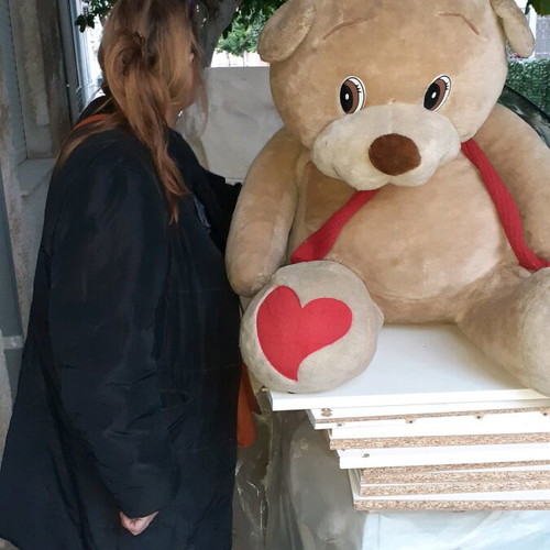 XXL teddy bear used with red bow and hearts