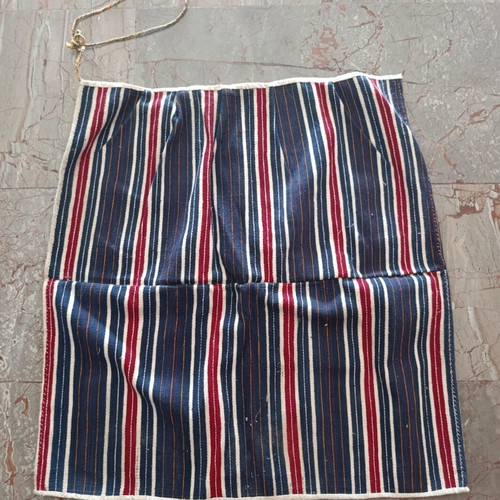 Traditional apron with vertical stripes used