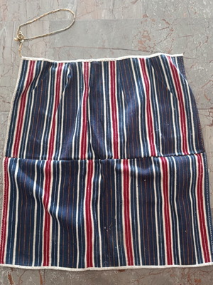 Traditional apron with vertical stripes used