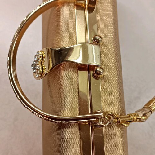 Gold evening handbag like new with missing rhinestone