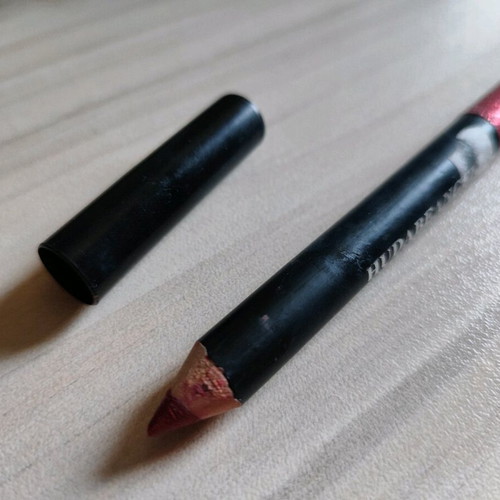 Lip pencil used dark red with glitter