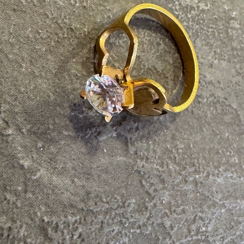 Gold-colored ring used with heart design and zircon stone