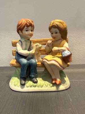 Porcelain decoration with two children on bench like new