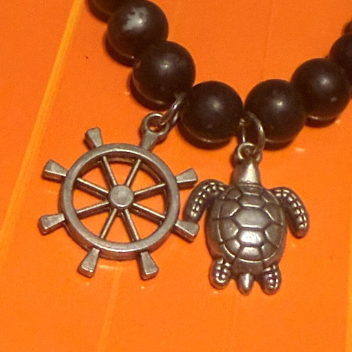 Elastic bracelet like new with steering wheel and turtle charms black-silver