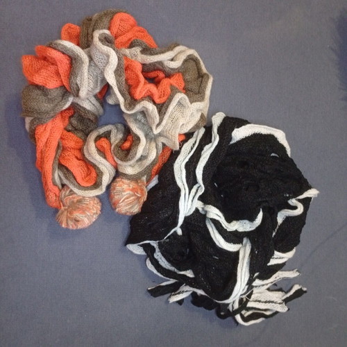 Set of 2 knitted Sprider scarves like new, black and white and orange with pom-poms
