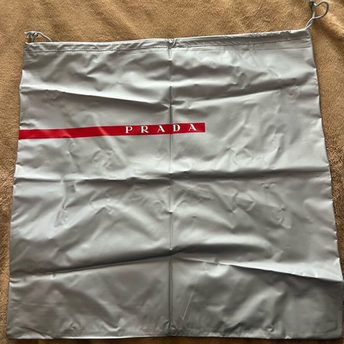 Prada case new, grey with red logo