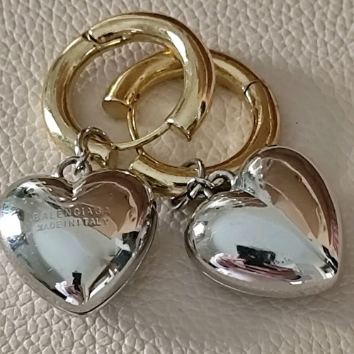 Balenciaga earrings with two tone dangling hearts like new