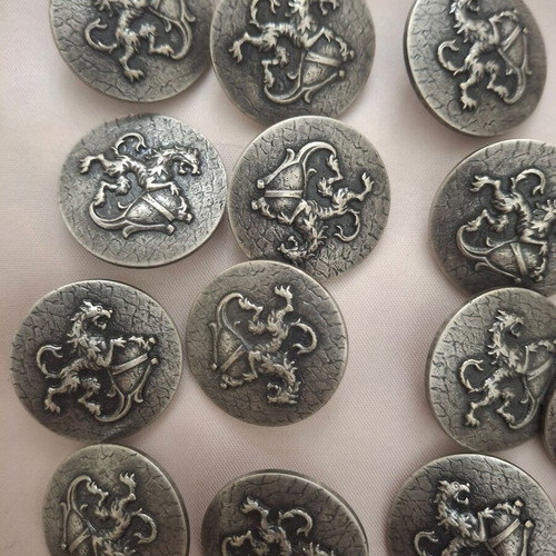 19 silver shield-style clothing buttons with lion design