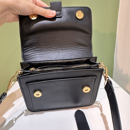 Black women's crossbody shoulder bag with gold details