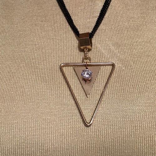 Pendant like new metal with 4-row black and gold chain with rhinestones