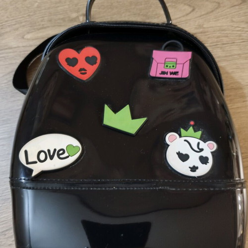 Small black backpack used with decorative patches