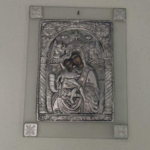 Glass icon of Panagia used, wall-mounted with silver relief
