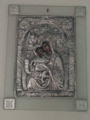 Glass icon of Panagia used, wall-mounted with silver relief