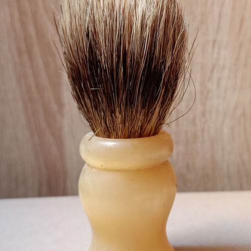 Two shaving brushes, one says it is made in West Germany.